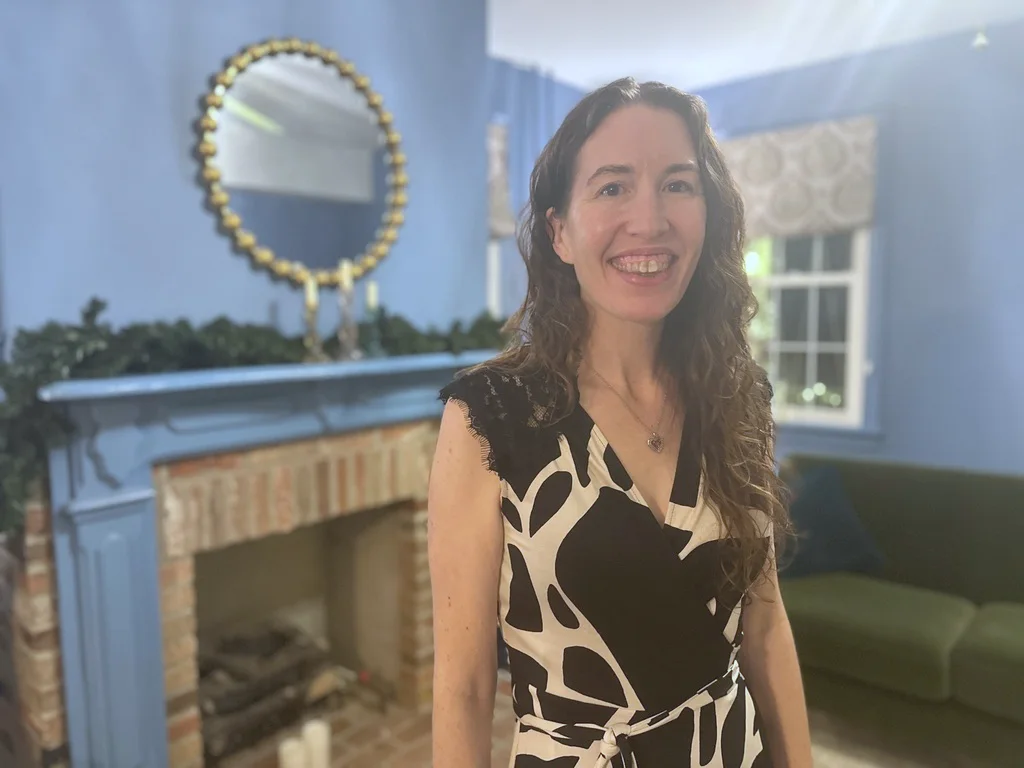 Emily Hunt-Adiletta smiling in the room where the workshop takes place.